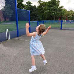 Full length of girl playing in a field