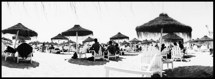 Panoramic view of people at town square against sky