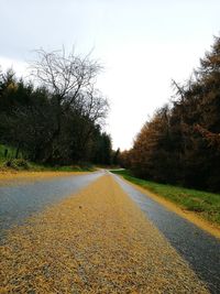 Surface level of road against clear sky