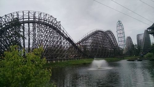 View of bridge over river against cloudy sky