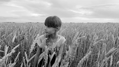 Full length of girl standing on field against sky