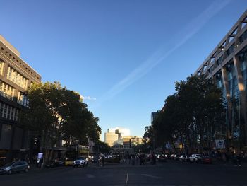 City street and buildings against blue sky