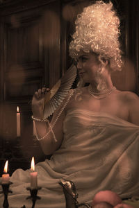 Woman holding lit candles