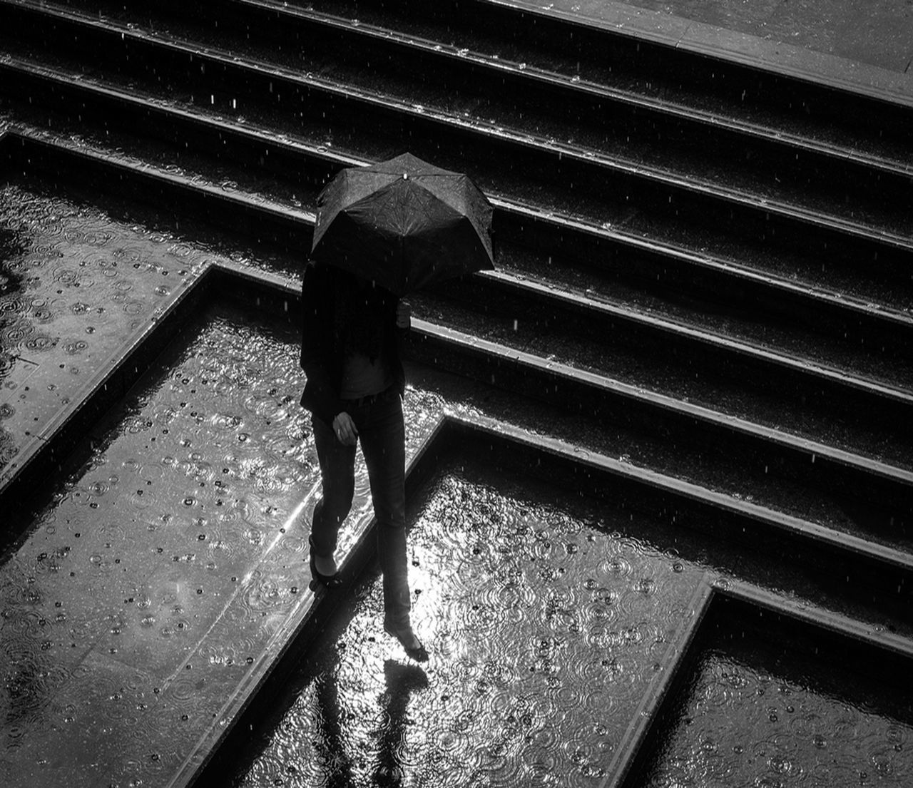 HIGH ANGLE VIEW OF PERSON WALKING ON STEPS