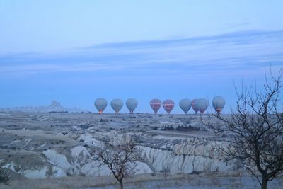 Hot air balloons at cappadocia against sky