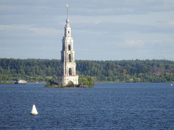 Scenic view of sea by building against sky