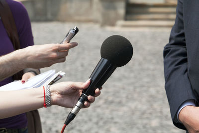 Close-up of hands holding camera