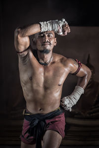 Portrait of shirtless man wearing mask