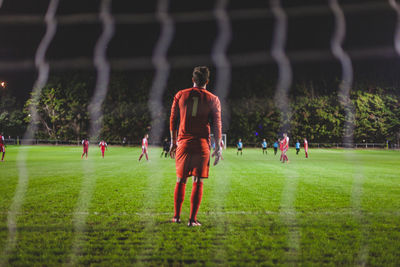 People playing soccer on field