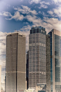 Low angle view of modern buildings against sky in city