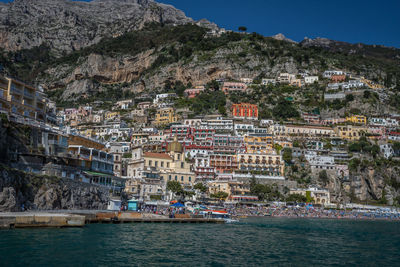 View of town by sea against mountain