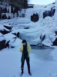 Model in front of frozen waterfall