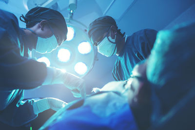 In a operating room, a doctor or medical team is performing a surgical procedure. person