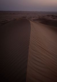 Scenic view of desert against sky during sunset