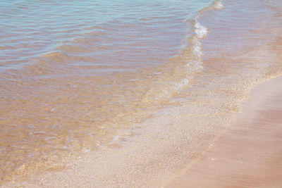 High angle view of waves rushing towards shore