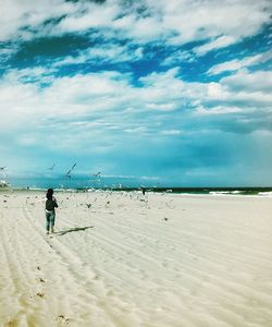 Man standing on beach against sky