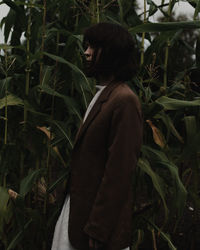 Side view of woman looking at plants