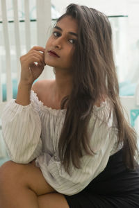 Portrait of woman sitting at home