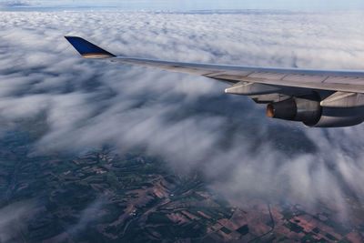 Cropped image of airplane flying over landscape