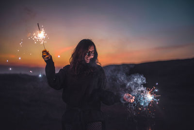 Man with fire crackers at night