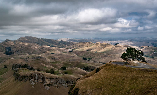 Scenic view of mountains against cloudy sky at dusk