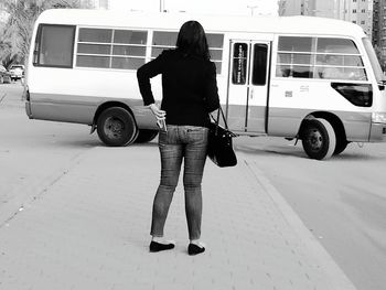 Rear view of mature woman standing on street