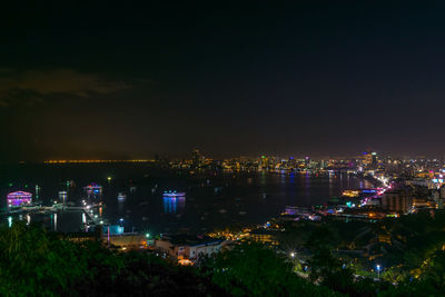 High angle view of illuminated buildings against sky at night