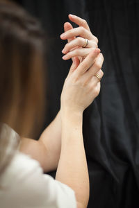 Midsection of woman holding hands with text