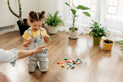 Mom and little daughter choose colorful plasticine for the game. the concept of preschool 