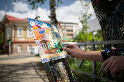 20th of may 2022, russia, tomsk, the street painter drawing building