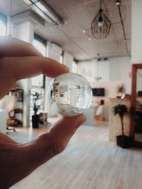 Close-up of hand holding crystal ball