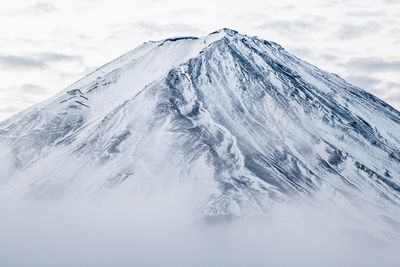 Scenic view of snow covered mountains against sky