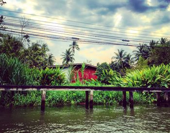 Scenic view of river against cloudy sky