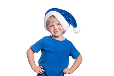 Portrait of smiling boy standing against white background