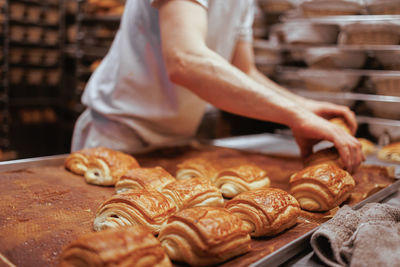 Midsection of baker preparing pastry 