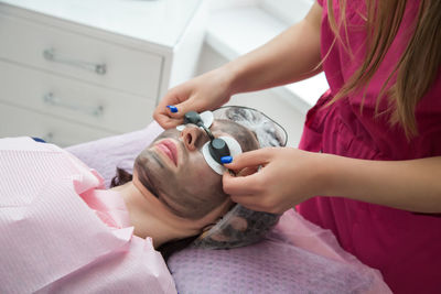 High angle view of woman applying nail