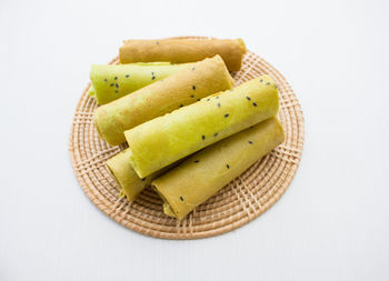 High angle view of fruits on table against white background