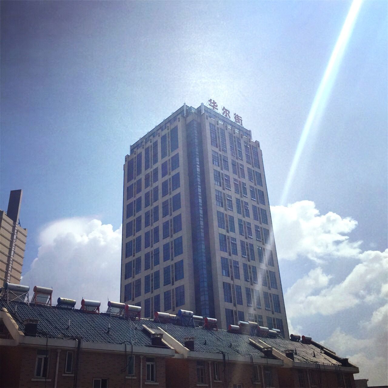 architecture, building exterior, built structure, low angle view, city, modern, sky, skyscraper, office building, tall - high, tower, building, blue, sunlight, glass - material, day, cloud - sky, outdoors, no people, cloud