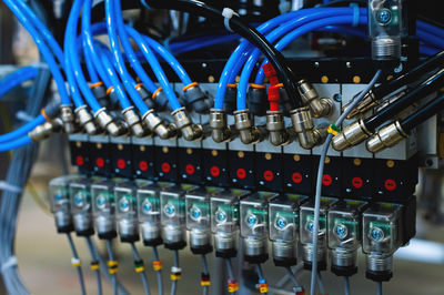 Pneumatic industrial conveyor machine with blue plastic tubes, industrial concept background