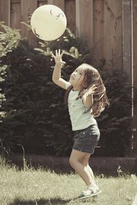 Full length of woman holding ball on field