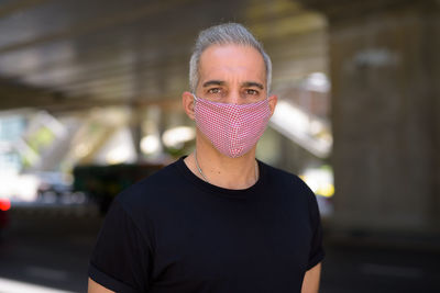 Portrait of man wearing sunglasses standing outdoors