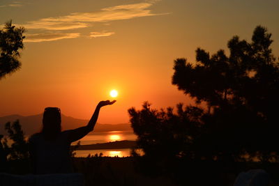 Silhouette trees against sky during sunset