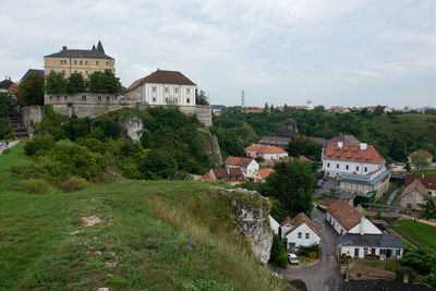 High angle view of buildings in town against sky