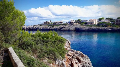 Panoramic view of townscape by sea against sky