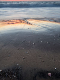 High angle view of wet shore during sunset