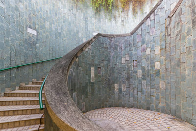 View of old staircase against wall