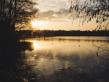 Scenic view of lake against sky during sunset