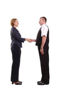 Side view of a couple standing against white background