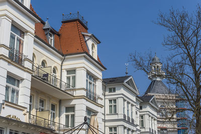 Low angle view of buildings against blue sky