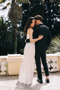 A beautiful couple in love, bride and groom in wedding clothes, walk and pose in the park in nature